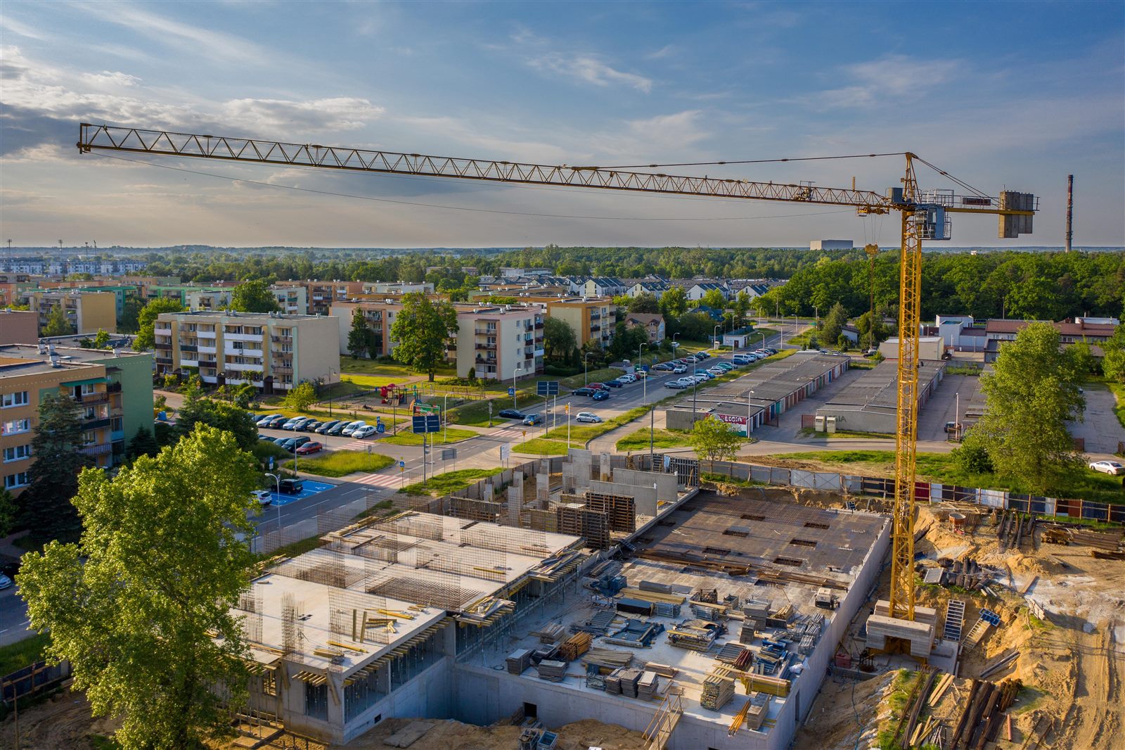 Aerial construction site overview during foundation and earthwork phase