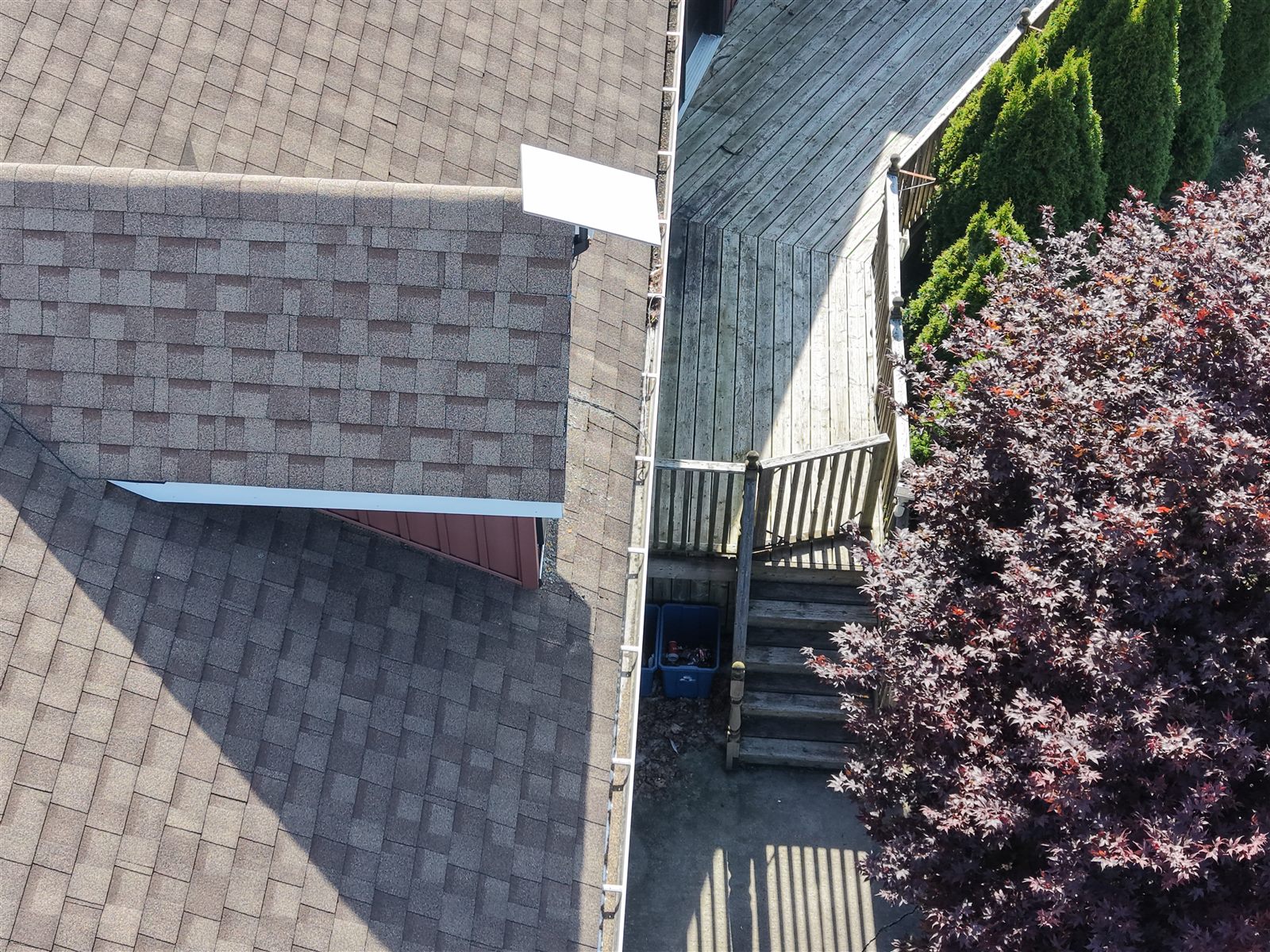Aerial drone close-up of roof shingles and flashing during a building inspection in Ontario